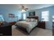 Bright bedroom with light blue walls, ceiling fan, and a decorative bed with plenty of pillows at 3100 Benton Cir, Raleigh, NC 27615