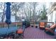 Well-appointed wooden deck features an outdoor dining set, grill, and comfortable seating perfect for entertaining at 3100 Benton Cir, Raleigh, NC 27615