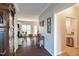 Inviting foyer with hardwood floors leads to a bright living area, featuring a view of the fireplace and natural light at 3100 Benton Cir, Raleigh, NC 27615