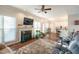 Comfortable living room with a fireplace, hardwood floors, and an adjacent kitchen and dining area at 3100 Benton Cir, Raleigh, NC 27615