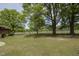 Spacious backyard featuring lush green grass and mature trees, perfect for outdoor activities at 3121 Blue Hill Ln, Durham, NC 27703