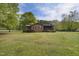 Charming single-story brick home with mature trees and a spacious front yard at 3121 Blue Hill Ln, Durham, NC 27703