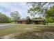 Brick home with a two car garage features a screened in porch and well-manicured lawn at 3121 Blue Hill Ln, Durham, NC 27703