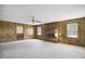 Spacious living room with a brick fireplace, ceiling fan and carpeted floors at 3121 Blue Hill Ln, Durham, NC 27703