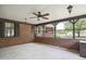 A screened porch with brick pillars, overhead lighting, ceiling fan and view of the backyard at 3121 Blue Hill Ln, Durham, NC 27703