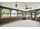 Screened porch with ceiling fan, overhead lighting and brick pillars overlooking the backyard at 3121 Blue Hill Ln, Durham, NC 27703