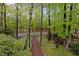 View of the lush backyard featuring a wooded area, privacy, and a walking path at 33 Stoneridge Cir, Durham, NC 27705