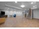 Spacious basement with tiled floors, a blue chair and a finished staircase at 33 Stoneridge Cir, Durham, NC 27705
