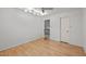 Neutral bedroom with hardwood floors, recessed lighting, and en suite door at 33 Stoneridge Cir, Durham, NC 27705