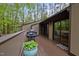 A cozy outdoor deck features seating, a grill, and sliding glass doors to the interior at 33 Stoneridge Cir, Durham, NC 27705