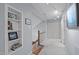Hallway with shelves and built-in storage, neutral carpet and updated lighting at 33 Stoneridge Cir, Durham, NC 27705