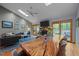 Living room featuring a large wood dining table and a fireplace with sliding door access to the outside at 33 Stoneridge Cir, Durham, NC 27705