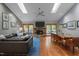 Spacious living room featuring hardwood floors, a stone fireplace, skylights, and a ceiling fan at 33 Stoneridge Cir, Durham, NC 27705
