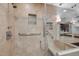 Walk-in shower with tile surround, bench, and glass door at 33 Stoneridge Cir, Durham, NC 27705