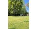 Expansive backyard featuring open-air structure, mature trees and plentiful space at 335 Ashley Ave, Timberlake, NC 27583