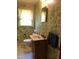 The bathroom showcases a unique wallpaper design, complemented by fixtures and finishes at 335 Ashley Ave, Timberlake, NC 27583