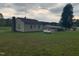 Back of single Gathering home with propane tank and outbuilding at 335 Ashley Ave, Timberlake, NC 27583