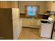 Classic kitchen with white appliances, linoleum floor and patterned wallpaper at 335 Ashley Ave, Timberlake, NC 27583