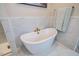 Close up of soaking tub with brass fixtures and marble tiling at 353 Murray Grey Ln, Wake Forest, NC 27587