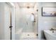 Bright bathroom featuring glass enclosed shower, soaking tub, and marble tiling at 353 Murray Grey Ln, Wake Forest, NC 27587