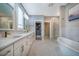 Bright bathroom with double vanity, soaking tub and glass enclosed shower at 353 Murray Grey Ln, Wake Forest, NC 27587