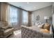 Cozy bedroom with tufted bed, sheer curtains, and patterned accent chair at 353 Murray Grey Ln, Wake Forest, NC 27587
