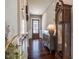 Hallway with wood floors, console table, and a grandfather clock leading to the front door at 353 Murray Grey Ln, Wake Forest, NC 27587