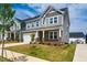 A beautiful, well-manicured lawn leads up to this craftsman style two story home with a two car garage at 353 Murray Grey Ln, Wake Forest, NC 27587
