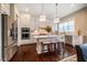 Modern kitchen featuring stainless steel appliances, an island with bar stools, and wooden floors at 353 Murray Grey Ln, Wake Forest, NC 27587