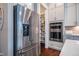 Modern kitchen featuring stainless steel refrigerator, white cabinets, double ovens and a well stocked pantry at 353 Murray Grey Ln, Wake Forest, NC 27587