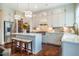 Contemporary kitchen with white cabinets, quartz countertops, stainless steel appliances, and central island with seating at 353 Murray Grey Ln, Wake Forest, NC 27587