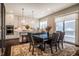 Open floor plan with a kitchen and dining area offering natural light, stainless steel appliances, and kitchen island at 353 Murray Grey Ln, Wake Forest, NC 27587