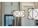 Kitchen with statement lighting fixtures above stainless steel appliances and white cabinets at 353 Murray Grey Ln, Wake Forest, NC 27587