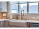 Kitchen sink with a gooseneck faucet, alongside neutral countertops, and an exterior view from the window at 353 Murray Grey Ln, Wake Forest, NC 27587
