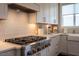 Well-appointed kitchen showcases stainless steel gas range, custom cabinetry, and stylish backsplash for cooking at 353 Murray Grey Ln, Wake Forest, NC 27587