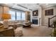 Cozy living room boasts a fireplace, plush sofa, coffered ceilings, and large windows for natural light at 353 Murray Grey Ln, Wake Forest, NC 27587