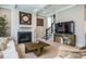 Living room with a fireplace, coffered ceiling, and a staircase leading to the second floor at 353 Murray Grey Ln, Wake Forest, NC 27587