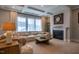 Cozy living room with a fireplace and large windows at 353 Murray Grey Ln, Wake Forest, NC 27587