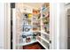 Walk-in pantry with custom shelving, ample storage, and organization to keep the kitchen clutter-free at 353 Murray Grey Ln, Wake Forest, NC 27587