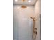 Close up of tile shower featuring brass shower head and fixtures at 353 Murray Grey Ln, Wake Forest, NC 27587