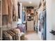 Spacious walk-in closet with custom shelving, drawers, and hanging storage at 353 Murray Grey Ln, Wake Forest, NC 27587