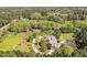 Aerial view showcases home, surrounded by lush greenery, complemented by white fences at 40 Farrells Creek Rd, Apex, NC 27523