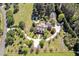 Expansive aerial view of a secluded estate showcasing lush landscaping and a winding driveway at 40 Farrells Creek Rd, Apex, NC 27523