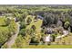 Scenic aerial view of the property with lush greenery, white fences, and multiple homes at 40 Farrells Creek Rd, Apex, NC 27523