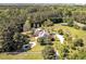 Aerial view with lush greenery, white fences, circular driveway, and serene pool at 40 Farrells Creek Rd, Apex, NC 27523