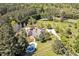 Aerial view of home with pool, circular driveway, white fence and manicured landscaping at 40 Farrells Creek Rd, Apex, NC 27523