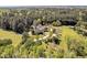 Aerial view with lush greenery, white fences, circular driveway, and serene pool at 40 Farrells Creek Rd, Apex, NC 27523