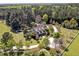 Stunning aerial view with lush greenery, white fences, circular driveway, and serene pool at 40 Farrells Creek Rd, Apex, NC 27523