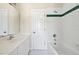 A classic bathroom features white cabinetry, tile, and a shower/tub combo at 40 Farrells Creek Rd, Apex, NC 27523