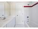 A classic bathroom features white cabinetry, tile, and a shower/tub combo at 40 Farrells Creek Rd, Apex, NC 27523